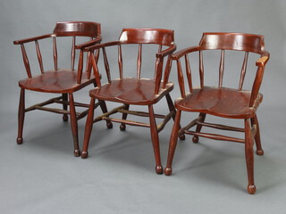 A set of three elm and beech smokers bow chairs with H framed stretcher 