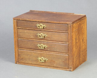 An oak table top chest of 4 long graduated drawers with brass drop handles 25cm h x 34cm w x 20cm d 