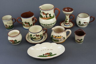 A mottoware milk jug, 17cm, a ditto chamber stick and a quantity of motto ware vessels