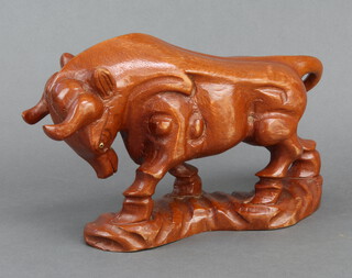 A carved wood figure of a standing bull 19cm 