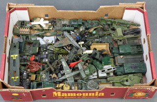 A collection of various toy and military vehicles contained in a fruit box