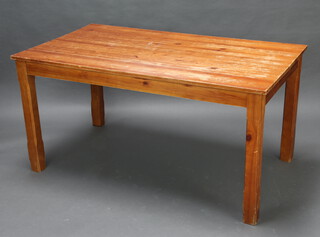 A rectangular pine kitchen table raised on square supports 74cm x 150cm x 84cm (contact marks to the top)