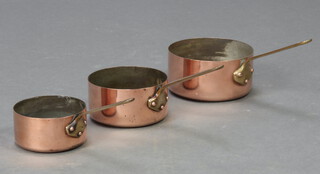 Three circular copper and brass saucepans 8cm x 17cm, 7cm x 14cm and 6cm x 12cm