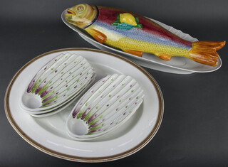 An Italian pottery fish tureen in the form of a fish 61cm x 10cm x 17cm, a Continental boat shaped salmon dish 67cm x 22cm, a white oval meat plate with Grecian key decoration 51cm x 40xm together with five asparagus dishes 6cm x 16cm