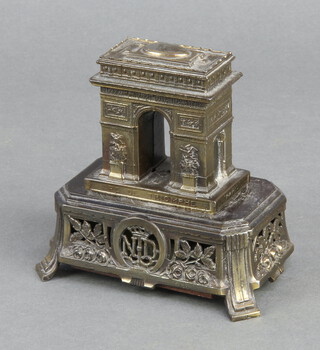 A metal model of the L'Arc de Triomphe with musical box base 