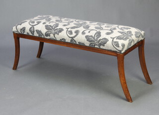 A 19th Century style mahogany window seat upholstered in grey floral material, raised on sabre supports 45cm h x 113cm w x 37cm d 