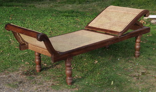 A Victorian style hardwood adjustable day bed, raised on turned supports with cane panels 57cm h x 205cm l x 70cm w (1 end is f) 