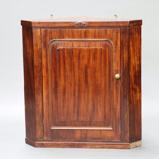 A 19th Century mahogany hanging corner cabinet enclosed by an arched panelled door 82cm h x 76cm w x 54cm d 