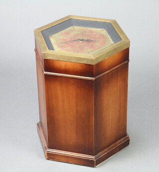 A Georgian style hexagonal mahogany pedestal cabinet, the lid set a timepiece and with brass banding 49cm h x 39cm x 34cm w 