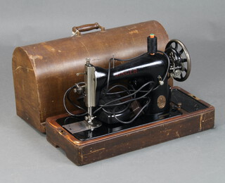 A Singer electric sewing machine no.F8207150, complete with carrying case and key 