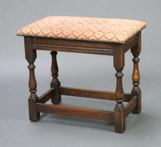 A rectangular oak stool with upholstered seat, raised on turned and block supports 48cm h x 55cm w x 36cm d 