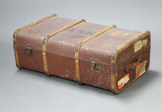 A fibre and wooden bound cabin trunk with Swiss and Victoria luggage labels 32cm h x 91cm w x 53cm d 