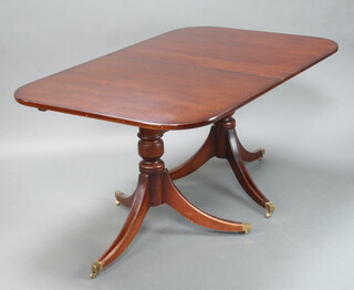 A Georgian style mahogany D end dining table, raised on pillar and tripod supports, brass caps and casters 76cm h x 100cm w x 162cm l 