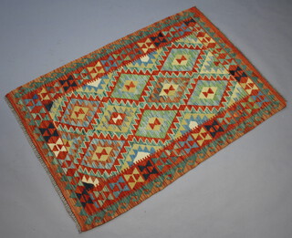 A yellow, green and turquoise ground Chobi Kilim rug 151cm x 103cm 