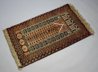 A brown and black ground Afghan prayer rug within multi row border 141cm x 86cm 