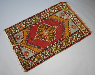 A red, orange and brown ground Afghan rug with central medallion within multi row border 160cm x 108cm 