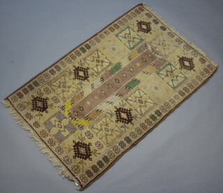 A Caucasian style green, white and brown ground rug with rectangular central medallion 139cm x 91cm 