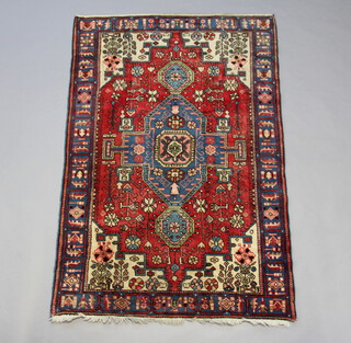 A blue, red and white ground Persian Navahand rug 199cm x 123cm 