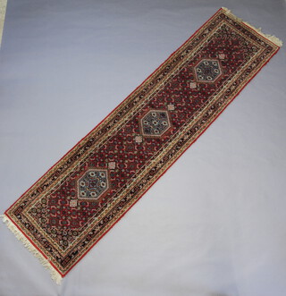 A blue, white and turquoise ground Bidjar runner with 3 stylised diamonds to the centre within a multi row border 352cm x 89cm 