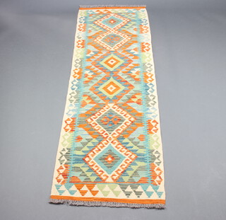 A yellow, green and white ground Chobi Kilim runner with 6 diamonds to the centre 199cm x 63cm 