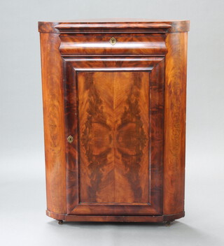 A 19th Century Continental walnut corner cabinet with moulded top above secret drawer and cupboard enclosed by a panelled door, raised on cast supports 133cm h x 64cm w x 64cm d 