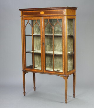 An Edwardian inlaid mahogany display cabinet with moulded cornice, fitted shelves enclosed by astragal glazed panelled doors, raised on square tapered supports, spade feet 151cm h x 91cm w x 38cm d 