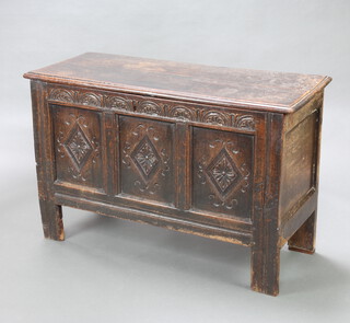A 17th/18th Century carved oak coffer with hinged lid, the interior fitted a candle box, 79cm h x 124cm w x 49cm d 