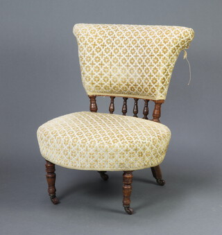 An Edwardian oak framed nursing chair with bobbin turned decoration upholstered in yellow material, raised on turned supports 70cm h x 54cm w x 52cm d (seat 38cm x 36cm)  