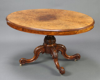 A Victorian oval figured walnut and quarter veneered Loo table, raised on a carved column and tripod base 76cm h x 136cm w x 102cm d  