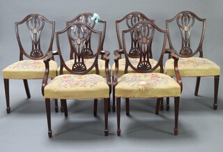 A set of 6 Edwardian inlaid mahogany Hepplewhite style dining chairs, the seats upholstered in woolwork 