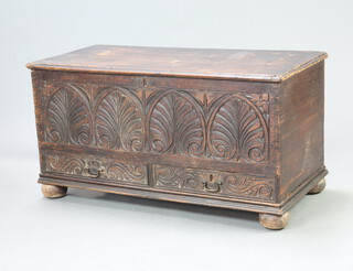An 18th/19th Century carved oak mule chest with hinged lid, the base fitted 2 drawers, raised on bun feet 58cm h x 110cm w x 51cm d 