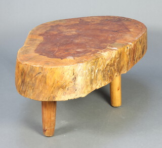 A rustic oak table formed from a tree trunk, raised on turned beech supports 52cm h x 120cm l x 78cm w