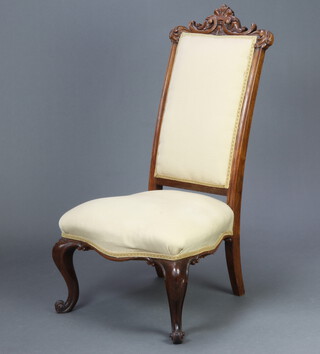 A Victorian carved rosewood show frame nursing chair upholstered in white material, raised on cabriole supports 104cm h x 51cm w x 45cm d (seat 35cm x 29cm) 