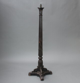 A Victorian turned and fluted mahogany bedpost converted for use as a standard lamp, raised on shaped base 156cm h x 44cm w x 44cm d 