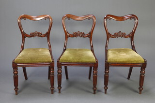 A set of 3 Victorian carved mahogany spoon back dining chairs with carved mid rails and upholstered drop in seats raised on turned and reeded supports 85cm h x 45cm w x 41cm d (seat 29cm x 28cm) 