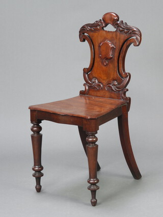 A Victorian carved mahogany hall chair with shaped back and solid seat of serpentine outline, raised on turned supports 84cm h x 41cm w x 36cm d (seat 28cm x 28cm) 