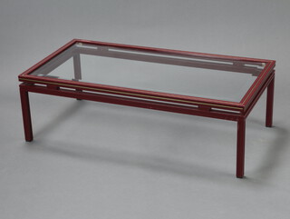 Pierre Vandel, a mid-Century red and gilt metal rectangular coffee table with bevelled plate glass panel to the centre 33cm h x 105cm w x 54cm d  