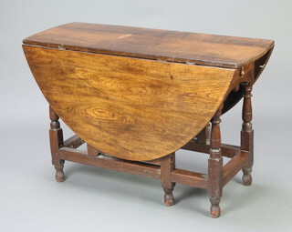 An 18th Century oak oval drop flap gateleg dining table fitted 2 frieze drawers, raised on turned and block supports 76cm h x 119cm w x 44cm when closed x 142cm when open 