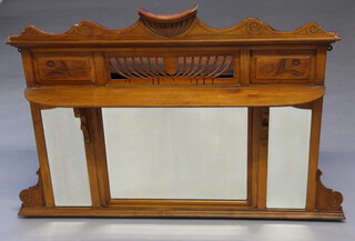 An Edwardian Art Nouveau triple plate over mantel mirror contained in a pierced and carved walnut frame 99cm h x 127cm w x 9cm d 