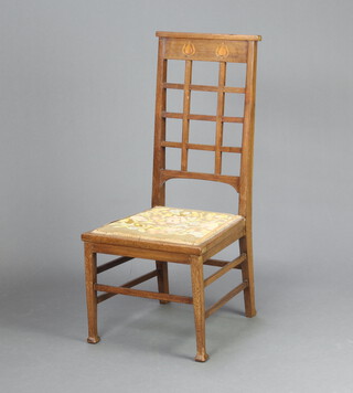 A Mackintosh style Art Nouveau inlaid mahogany bedroom chair with lattice work back, Berlin woolwork seat, raised on square supports 87cm h x 35cm w x 40cm d (seat 25cm x 26cm) 