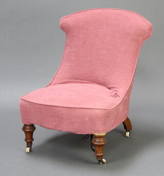 A Victorian nursing chair with pink loose cover, on turned supports 73cm h x 53cm w x 49cm d (seat 42cm w x 37cm d)