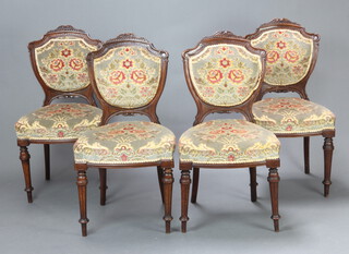 A set of 4 Victorian carved walnut show frame dining chairs, the seats and backs upholstered in green sculpted dralon, raised on turned and fluted supports 91cm h x 49cm w x 40cm d (seat 30cm x 28cm) 