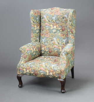 A winged armchair upholstered in tapestry material 110cm h x 72cm w x 65cm d (seat 30cm x 40cm) 