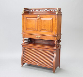 A Shoolbred style mahogany students bureau with pierced 3/4 gallery, the fall front above 1 long drawer with recess, the base enclosed by a tambour shutter 113cm h x 70cm w x 27cm d 