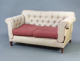 An Edwardian drop arm sofa upholstered in buttoned material 70cm h x 144cm w x 79cm (seat 96cm x 60cm) 