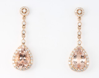 A pair of 18ct rose gold pear cut morganite approx. 5.74ct and diamond approx. 1.01ct earrings 35mm, 7 grams