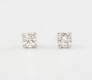 A pair of 18ct white gold single stone diamond ear studs 0.5ct, 1.5 grams