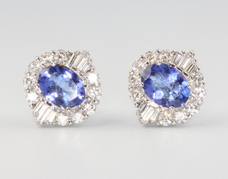 A pair of 18ct white gold oval tanzanite and diamond ear studs, the oval cut stones approx. 2.28ct, the diamonds 1.02ct, 13mm x 11mm, 5.2 grams