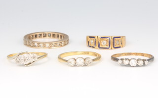 Four 18ct yellow gold gem set rings, size M, 10 grams and a yellow metal eternity ring 2 grams 