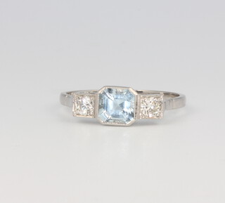 A platinum aquamarine and diamond 3 stone ring, the centre stone approx. 1.7ct, the brilliant cut diamonds 0.25ct, 3.2 grams, size P 1/2